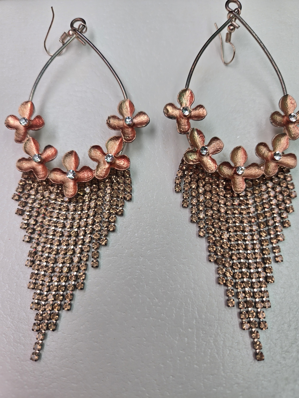 statement earrings featuring rose gold-toned metal flowers and champagne-colored
